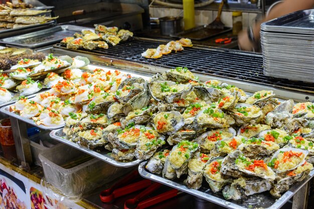 Sanya, Hainan/China - January 7, 2020: Chinese street food. Street trading. Chinese kinds of fresh seafood at an asian seafood market in Sanya, Hainan province, China. Inscription: name food.