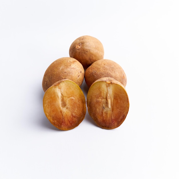 Sapodilla and fresh fruit isolated on a white background