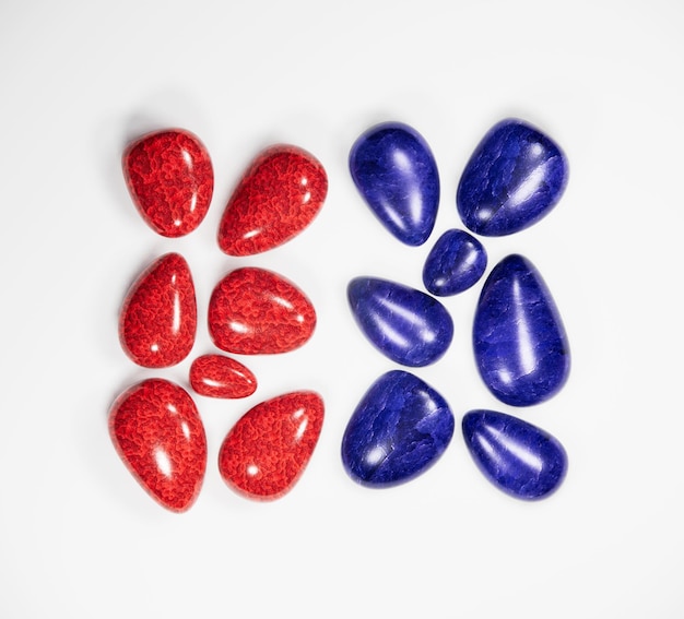 Sapphire and ruby stone flat lay on white background