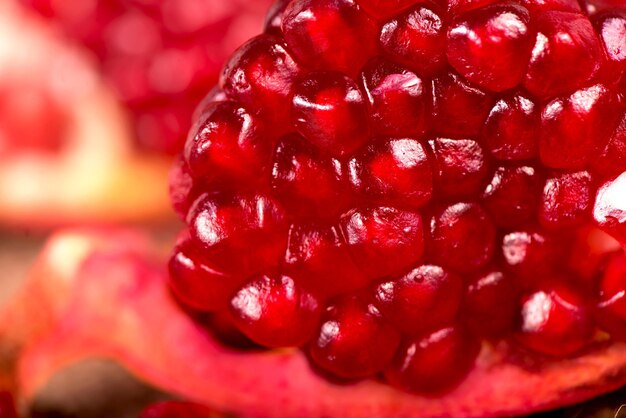 Sappige granaatappel en zijn helft met bladeren Mooie compositie met sappige granaatappels, op oude houten tafel