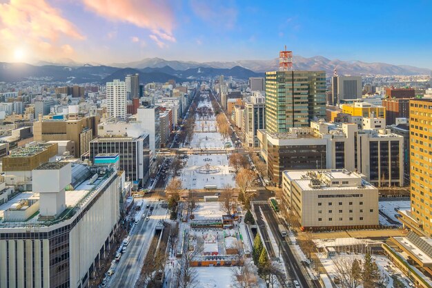 Photo sapporo city downtown skyline cityscape of japan sunset