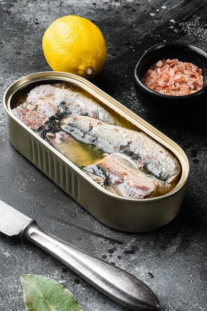 Sardine cans of preserves set, on black dark stone table background