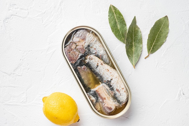 Photo sardine cans of preserves set, on white stone table background, top view flat lay, with copy space for text