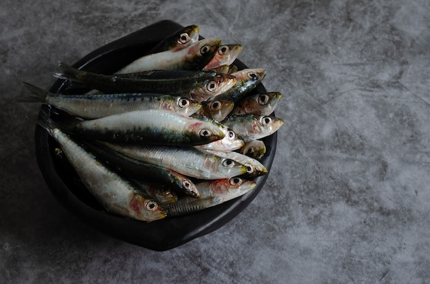 Sardines in a ceramic bowl on a marble table