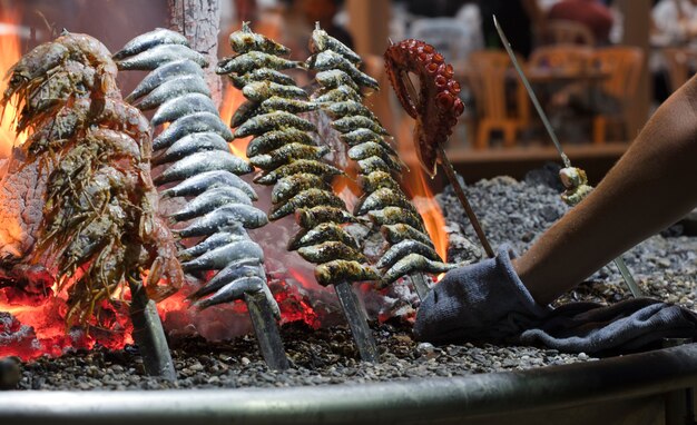 sardines to the fire on the beach