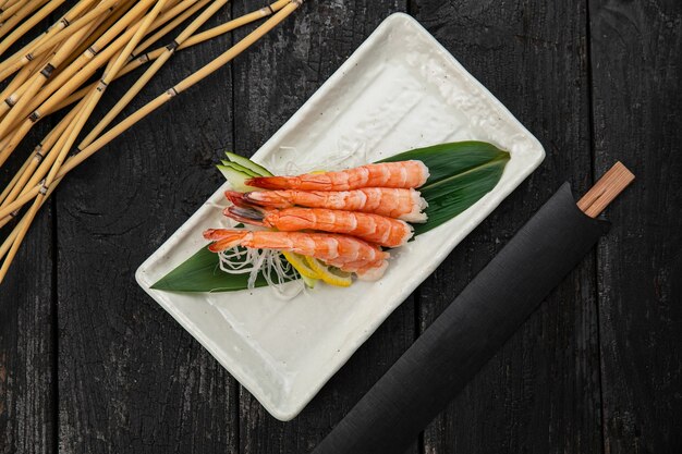 Sashimi on a plate on a dark table Japanese cuisine