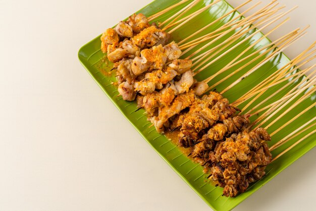 Sate taichan or Taichan satay with grilled chicken skin served with chili sauce