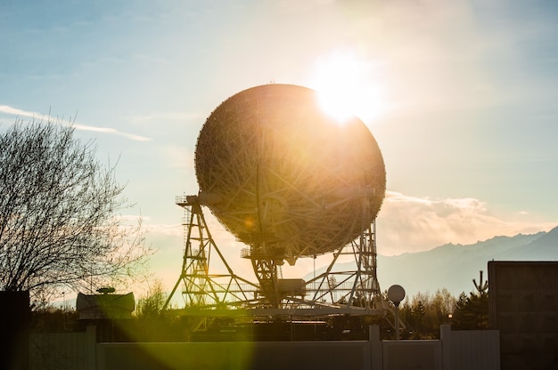 Photo satellite dishes on summit at sun day.