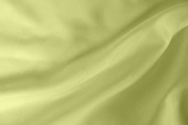 Satin crumpled fabric of light olive color top view