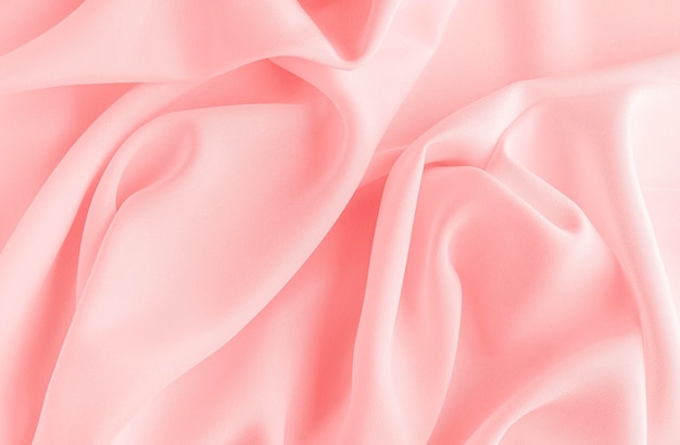 Satin silk fabric pink color for the background Crumpled wavy silk Texture of satin fabric