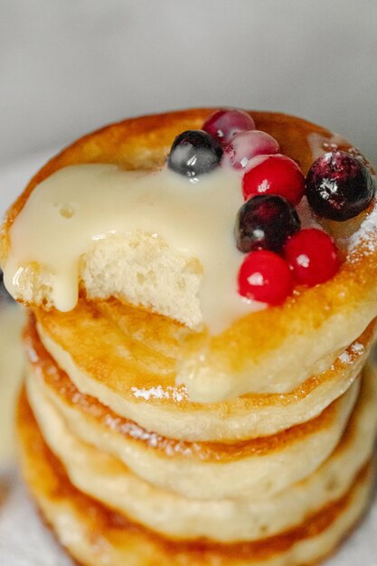 Satisfaction of hunger a stack of pancakes with blueberries and white frosting