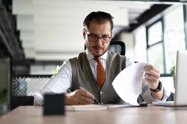 Satisfied businessman reading paper documents letters receiving pleasant news freelancer looking at contract with good offer