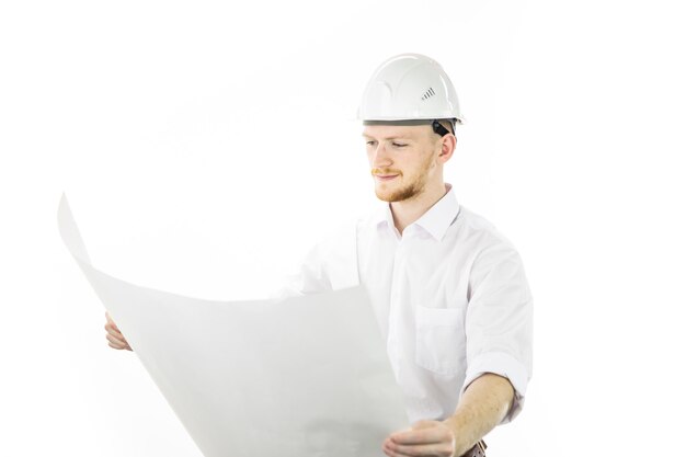 Satisfied handsome engineer in safety helmet working with blueprint documents