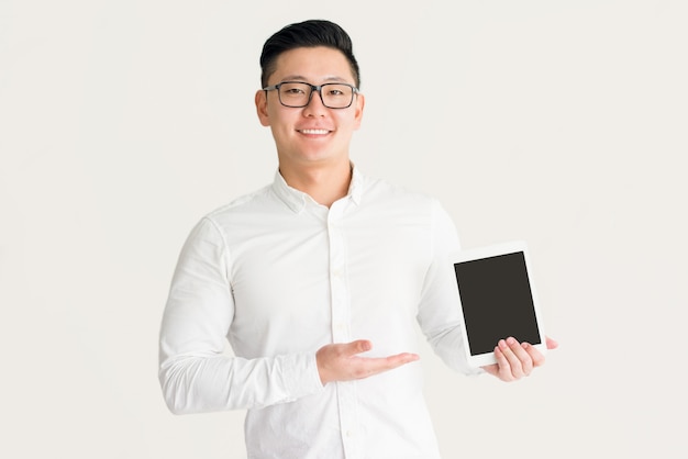 Satisfied Korean salesman presenting new device