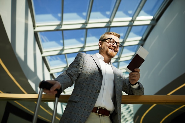 Satisfied man getting on plane for business trip