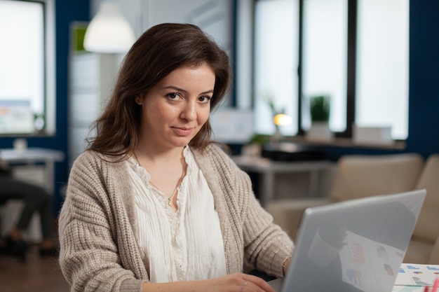 Satisfied manager checking financial statistics and graphs