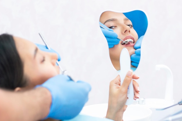 Foto paziente soddisfatto dal dentista. che mostra il suo sorriso perfetto dopo il trattamento in clinica