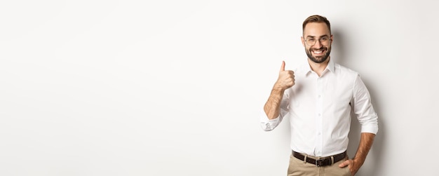 satisfied successful boss showing thumb up approve and praise good work standing over white backgrou