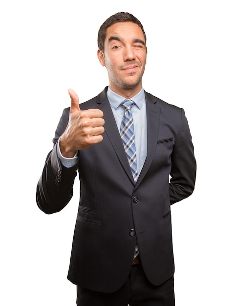 Satisfied young businessman doing an approval gesture