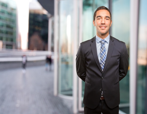 Satisfied young businessman posing