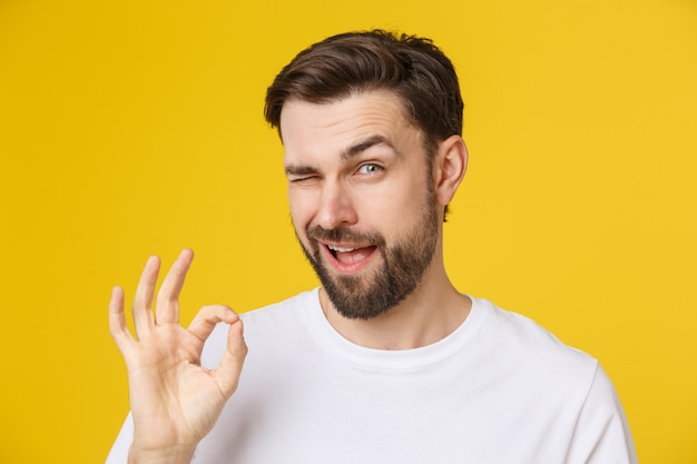 Satisfied young man showing okay sign