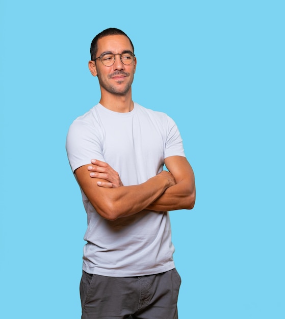 Satisfied young man with crossed arms gesture