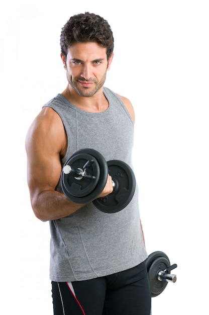 Satisfied young strength man lifting dumbbell isolated on white background