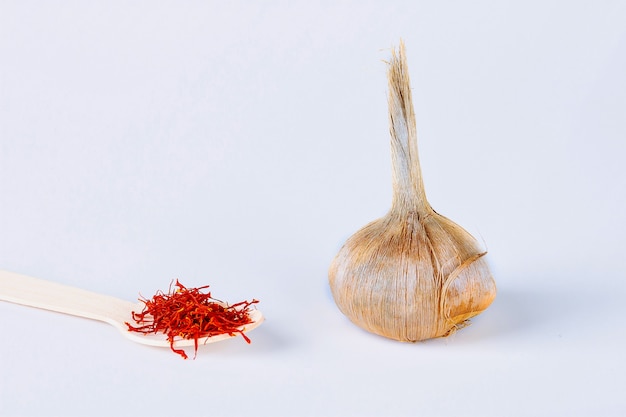 Sativus crocus bulb, stamens of dry spice saffron on a white background.