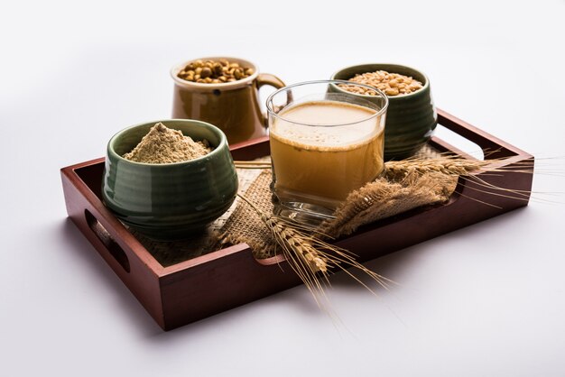 Sattu sharbat is a cooling sweet drink made in summer with roasted black chickpea flour, barley, suger, salt & water. served in a glass. selective focus