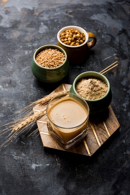 Sattu sharbat is a cooling sweet drink made in summer with roasted black chickpea flour, barley, suger, salt & water. served in a glass. selective focus