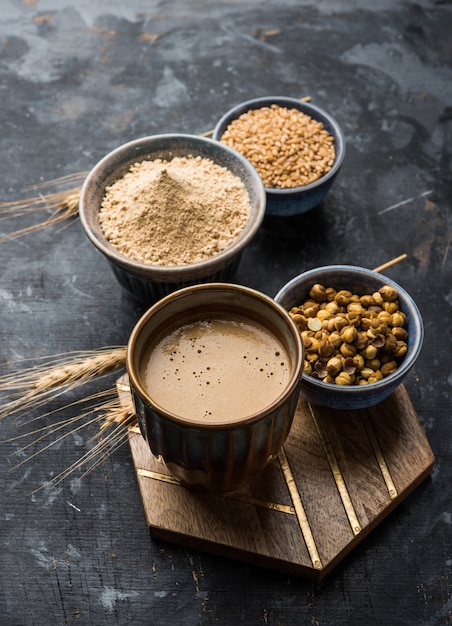 Sattu sharbat is a cooling sweet drink made in summer with roasted black chickpea flour, barley, suger, salt & water. served in a glass. selective focus