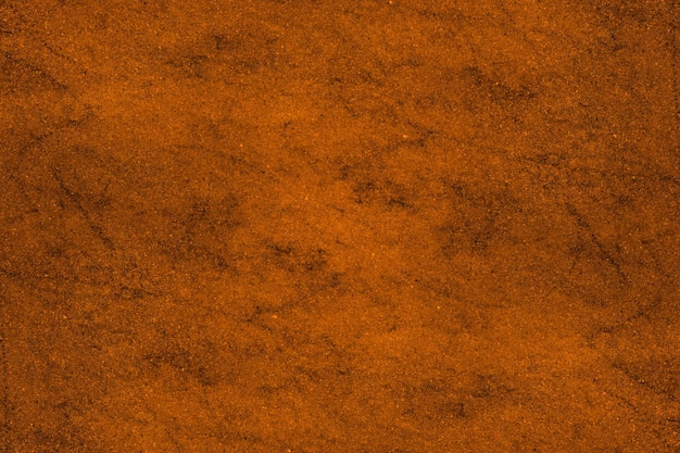 Saturated orange color old cement plaster wall with spots and grunge texture for background