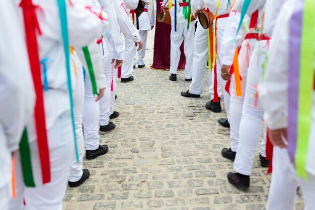 Saubara Bahia Brazil August 03 2019 Men women and children members of the cultural group Cheganca dos Marujos dance and sing in costumes during a performance at the streets of Saubara Bahia