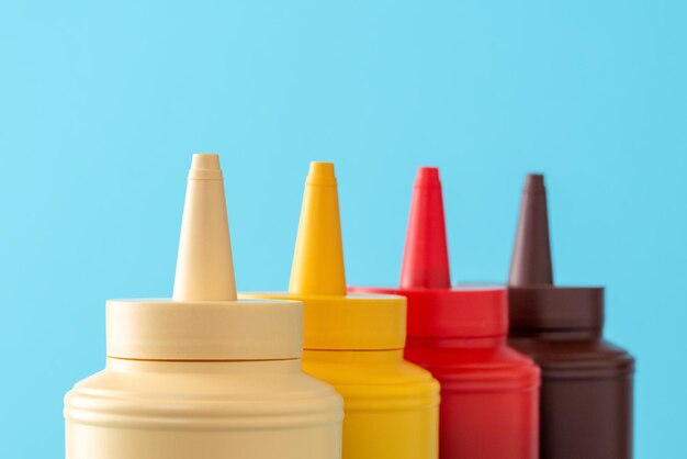 Sauce bottles close up on a blue background Sauces variety