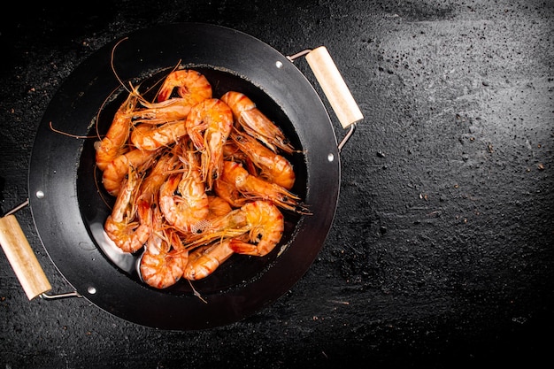 Saucepan with cooked boiled shrimp