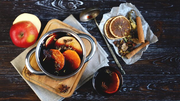 Saucepan with hot mulled wine Spices and citrus Christmas drinks Cooking mulled wine