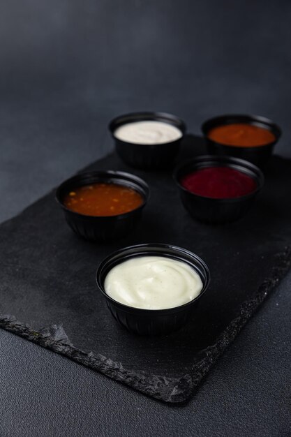 sauces of Asian cuisine on a black background