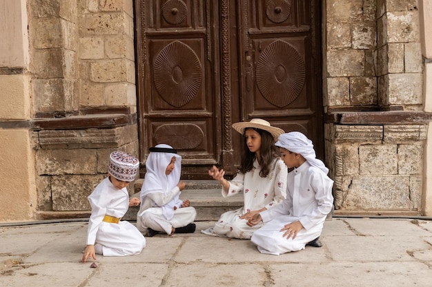 Saudi Arabian kids playing outside the house in Jeddah old town Saudi Srabia