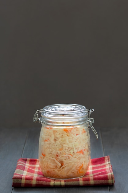 Sauerkraut, fermented cabbage and carrots salad in a glass jar. 