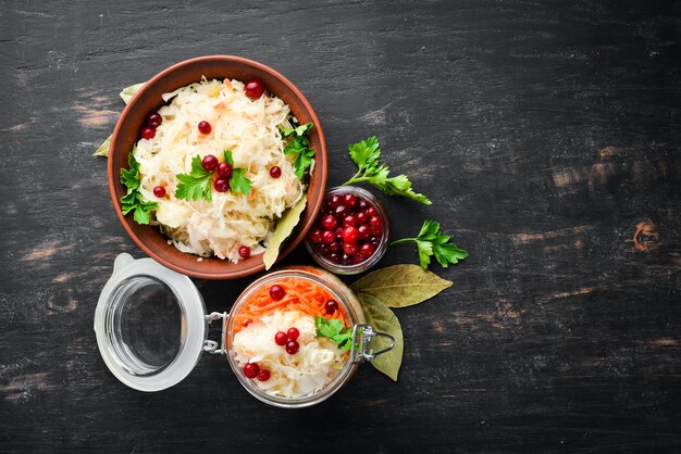 Sauerkraut in a jar on a kitchen table. Cabbage, cauliflower. Top view. Free space for your text.