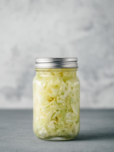 Photo sauerkraut in open glass jar copy space