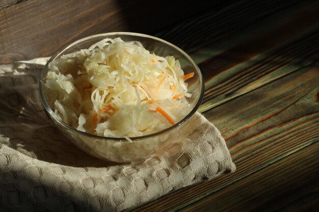 sauerkraut with ingredients on wooden background