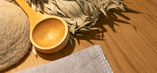 sauna accessories in the steam room. Brush, soap, broom, hat, linen towel. Flat lay. Copy space.