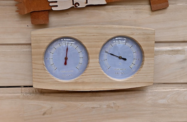 Sauna thermometer and hygrometer on wooden wall Temperature in celsius