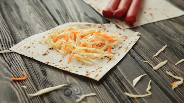 Sausage cabbage and pita bread isolated on wooden background