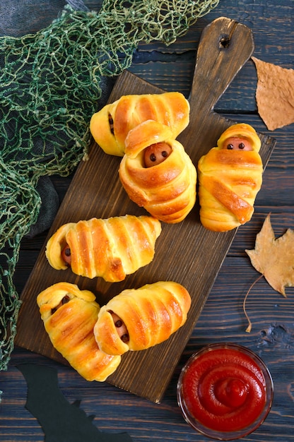 Sausage in dough with ketchup on the table