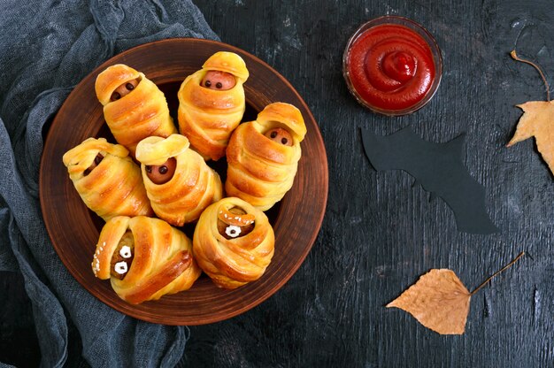 Sausage in dough with ketchup on the table