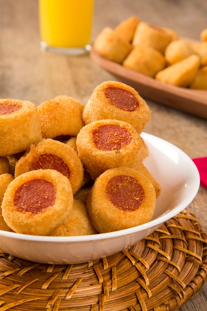 Sausage fried snacks. Brazilian snacks on wooden background.