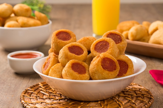 Sausage fried snacks. Brazilian snacks on wooden background.