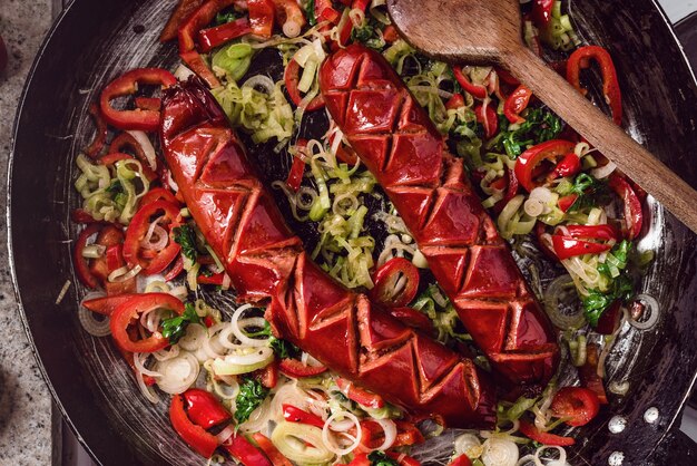 Sausage and mix of fresh vegetables fried in the rustic pan